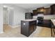 Well-equipped kitchen featuring black appliances, an island, and neutral countertops at 10016 Jenna Ln, Indianapolis, IN 46239