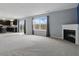 Inviting living room area featuring a fireplace, large windows, and seamless transition to the kitchen at 10016 Jenna Ln, Indianapolis, IN 46239