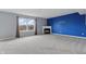 Bright living room features plush carpeting, a classic fireplace, and a bold accent wall at 10016 Jenna Ln, Indianapolis, IN 46239