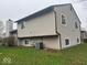 Back exterior view of home with siding, showing backyard lawn and chimney at 10047 Lone Wolf Dr, Indianapolis, IN 46235
