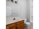 Traditional bathroom featuring a wood vanity, a large mirror, and a shower-tub combination at 10109 Fergus Ave, Carmel, IN 46032