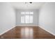 Bright bedroom featuring hardwood floors, large windows, and neutral paint, creating a serene atmosphere at 10109 Fergus Ave, Carmel, IN 46032