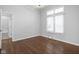 Bedroom with hardwood floors and a large window, leading to an attached bathroom and closet at 10109 Fergus Ave, Carmel, IN 46032