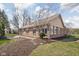 Backyard view of a one-story brick home with well maintained landscaping at 10109 Fergus Ave, Carmel, IN 46032