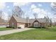 Attractive brick home featuring an attached garage, a curved driveway, and well-maintained landscaping at 10109 Fergus Ave, Carmel, IN 46032