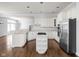 Bright kitchen with white cabinets, stainless steel appliances, and a functional island at 10109 Fergus Ave, Carmel, IN 46032