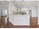 Open kitchen with white cabinets, stainless steel appliances, and a convenient breakfast bar at 10109 Fergus Ave, Carmel, IN 46032