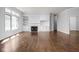 Spacious living room featuring hardwood floors, built-in cabinets, fireplace, and natural light from large windows at 10109 Fergus Ave, Carmel, IN 46032