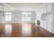 Open-concept living room featuring hardwood floors, built-in shelving, a fireplace, and plenty of natural light at 10109 Fergus Ave, Carmel, IN 46032