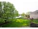 Beautiful backyard with views of the lake, the house and a deck and patio at 10365 Aurora Ct, Fishers, IN 46038