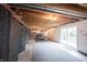 Unfinished basement featuring exposed ceiling, sliding doors, and a partial view of a pool table at 10365 Aurora Ct, Fishers, IN 46038
