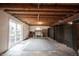 Unfinished basement featuring exposed ceiling, sliding doors and large area rug at 10365 Aurora Ct, Fishers, IN 46038