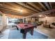 Basement featuring exposed ceiling, a pool table, seating, and soft lighting at 10365 Aurora Ct, Fishers, IN 46038