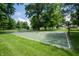 Community basketball court surrounded by lush trees and grass at 10365 Aurora Ct, Fishers, IN 46038