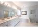 Bright bathroom with double vanity, soaking tub, and walk-in shower at 10365 Aurora Ct, Fishers, IN 46038