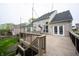 Spacious deck with double French doors to the house, featuring wood railings and scenic backyard views at 10365 Aurora Ct, Fishers, IN 46038
