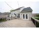 Expansive deck area leading to a beautiful white brick home with a well-manicured lawn at 10365 Aurora Ct, Fishers, IN 46038
