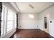 Dining room featuring hardwood floors, wainscoting, large windows, and modern light fixture at 10365 Aurora Ct, Fishers, IN 46038