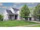 Attractive two-story brick home with a well-kept lawn, covered porch, and attached two-car garage at 10365 Aurora Ct, Fishers, IN 46038