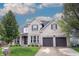 Beautiful two-story brick home featuring a two-car garage, well-manicured lawn, and mature trees at 10365 Aurora Ct, Fishers, IN 46038