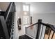 Elegant foyer featuring grand staircase with black metal railing and a chandelier at 10365 Aurora Ct, Fishers, IN 46038