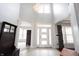 Grand foyer featuring soaring ceilings, tile floors, a modern chandelier, and an abundance of natural light at 10365 Aurora Ct, Fishers, IN 46038