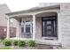 Inviting front porch with classic columns, a comfortable bench, and a stylish front door at 10365 Aurora Ct, Fishers, IN 46038