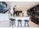 Modern kitchen featuring a breakfast bar that overlooks the living area at 10365 Aurora Ct, Fishers, IN 46038