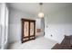 Bright living room with large windows, a vintage armoire, neutral carpet, and decorative lighting at 10365 Aurora Ct, Fishers, IN 46038