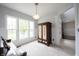 Bright living room with large windows, a vintage armoire, neutral carpet, and decorative lighting at 10365 Aurora Ct, Fishers, IN 46038