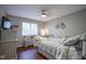 Cozy bedroom with hardwood floors, a large window, and a decorative bicycle accent at 1127 Island Woods Dr # 56, Indianapolis, IN 46220