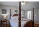 Spacious bedroom featuring a four-poster bed, hardwood floors, and soothing neutral tones at 1127 Island Woods Dr # 56, Indianapolis, IN 46220