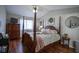 Bright bedroom featuring a wooden four-poster bed, wood floors and natural light at 1127 Island Woods Dr # 56, Indianapolis, IN 46220