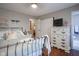 Comfortable bedroom featuring hardwood floors, a closet, and a stylish white dresser at 1127 Island Woods Dr # 56, Indianapolis, IN 46220