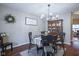 Traditional dining room features a round wood table, chandelier, and an antique china cabinet at 1127 Island Woods Dr # 56, Indianapolis, IN 46220
