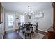 Cozy dining room with a wooden table, four chairs, and a stylish chandelier for ambient lighting at 1127 Island Woods Dr # 56, Indianapolis, IN 46220
