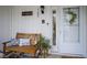 Inviting front porch with a bench, decorative pillows, and a charming wreath on the door at 1127 Island Woods Dr # 56, Indianapolis, IN 46220