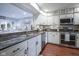 Well-lit kitchen boasts granite countertops, stainless steel appliances, and a view to the living area at 1127 Island Woods Dr # 56, Indianapolis, IN 46220