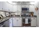 Bright kitchen with white cabinetry, stainless steel appliances, and stylish granite countertops at 1127 Island Woods Dr # 56, Indianapolis, IN 46220