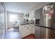 Cozy kitchenette area with stainless steel refrigerator and a charming seating area at 1127 Island Woods Dr # 56, Indianapolis, IN 46220