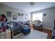 Cozy living room with a plush sofa, accent chair, area rug, and a window for natural light at 1127 Island Woods Dr # 56, Indianapolis, IN 46220