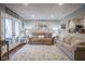 Spacious living room features plush seating, French doors, and an open view to the kitchen at 1127 Island Woods Dr # 56, Indianapolis, IN 46220