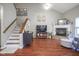 Open living room with fireplace, TV, and stairs leading to the second floor at 1127 Island Woods Dr # 56, Indianapolis, IN 46220