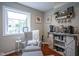 Charming sitting area with natural light, patterned armchair, and decorative shelving at 1127 Island Woods Dr # 56, Indianapolis, IN 46220