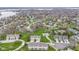 Aerial view of a residential neighborhood featuring townhouses, green spaces, and nearby lake at 11339 Fonthill Dr, Indianapolis, IN 46236