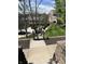Well-manicured backyard landscaping with grass and wood chip areas with a view of the home at 11339 Fonthill Dr, Indianapolis, IN 46236