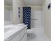 Clean bathroom with a tub and shower combination, complemented by nautical decor at 11339 Fonthill Dr, Indianapolis, IN 46236