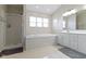 Elegant bathroom features a separate shower, a deep soaking tub, and marble-like tiling at 11339 Fonthill Dr, Indianapolis, IN 46236
