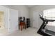 Spacious bedroom features neutral decor and a treadmill for convenient home workouts at 11339 Fonthill Dr, Indianapolis, IN 46236
