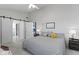 Comfortable bedroom with a bed, a ceiling fan, and barn doors leading to other rooms at 11339 Fonthill Dr, Indianapolis, IN 46236